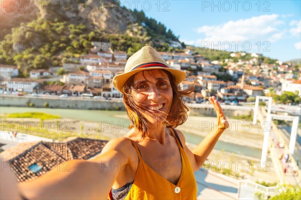 Selfie of a young woman on vacation in the historic town of Berat in Albania at sunset