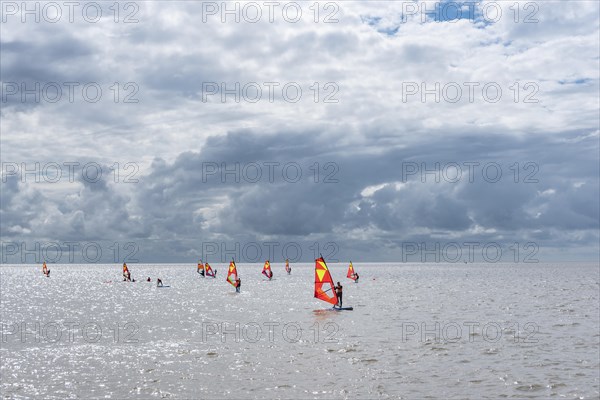 Windsurfers in front of the beach promenade