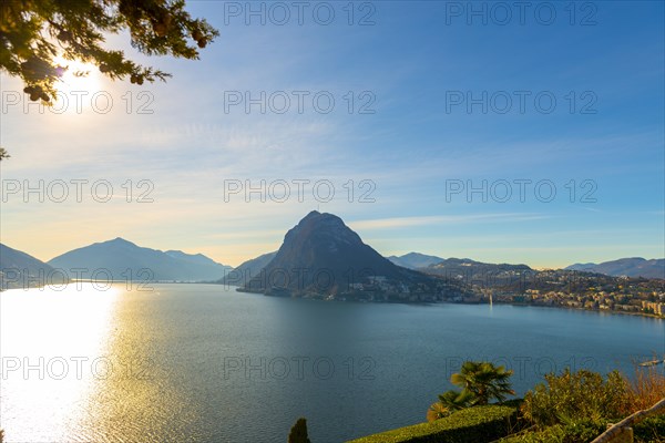 Tree Branch and Lake Lugano and City with Mountain and Blue Sky in Park San Michele in Castagnola in Lugano