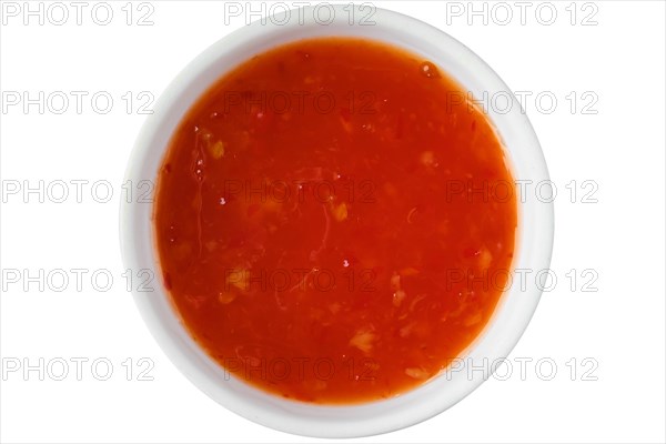 Top view of bowl with sweet chilli sauce isolated on white background