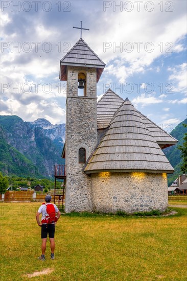 A tourist at the Catholic Church in the valley of Theth national park