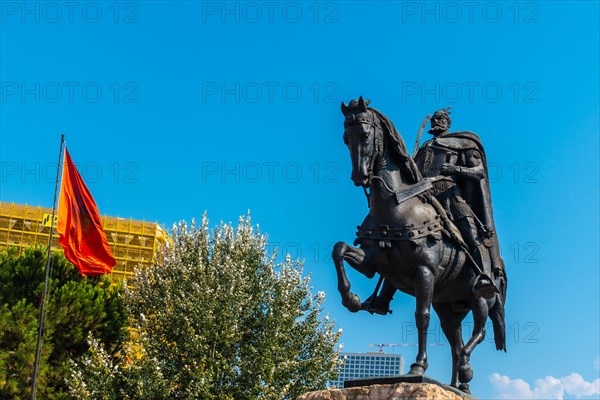 The beautiful Skanderbeg horse monument in Skanderbeg Square in Tirana and the red flag of Albania