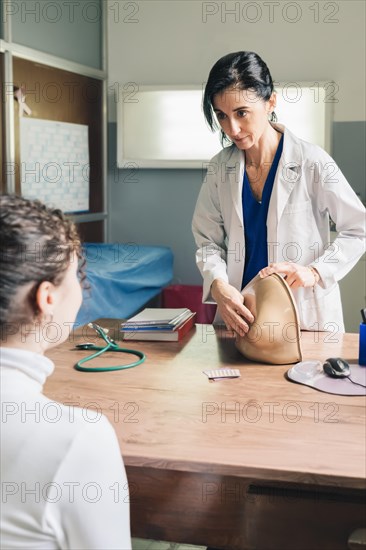 Gynecological doctor teaching breast self-examination. Fight against breast cancer