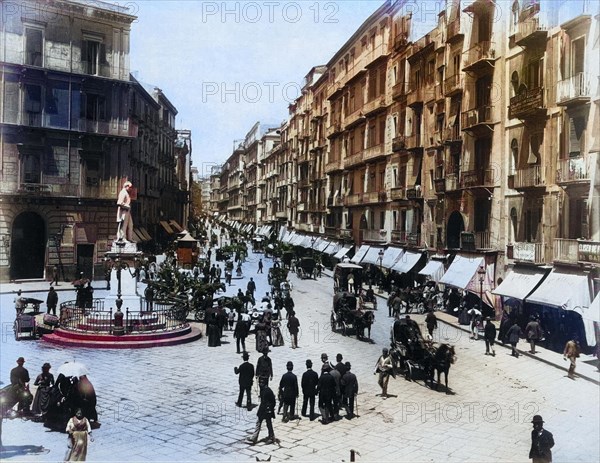 View of Via Roma in Naples with a statue