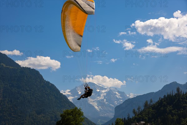 Paragliding in Front Of Snow Capped Jungfraujoch Mountain in a Sunny Day in Interlaken