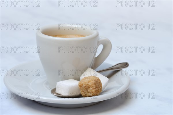 Espresso cup with white and brown sugar cubes