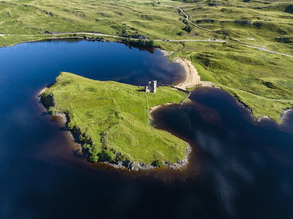 Aerial view of the freshwater loch Loch Assynt with the ruins of Ardvreck Castle on a peninsula