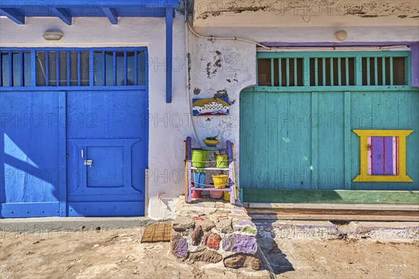 Colorful blue and green boat garage doors in Klima fishermen village