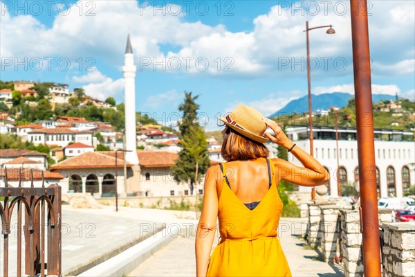 A young woman walking through the city of Berat in Albania in the summer holidays