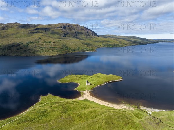 Aerial view of the freshwater loch Loch Assynt with the ruins of Ardvreck Castle on a peninsula