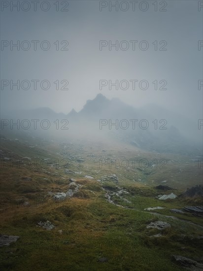 Transfagarasan mountain peak seen through the dense fog. Rainy scene in the mounts