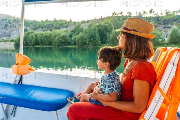 Mother with her son on a boat on a tourist excursion on Lake Shkoder in Shiroka. Albania