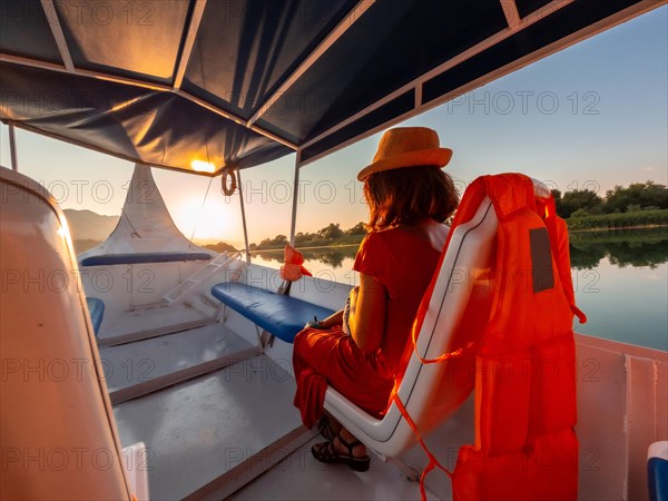 Tourist woman in a boat on a tourist excursion on Lake Shkoder in Shiroka. Albania