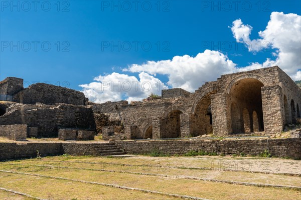 Fortress of the Ottoman castle of Gjirokaster or Gjirokastra and in the background the church with the clock tower. Albania