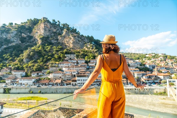 A young woman looking at the historic city of Berat in Albania from a viewing point