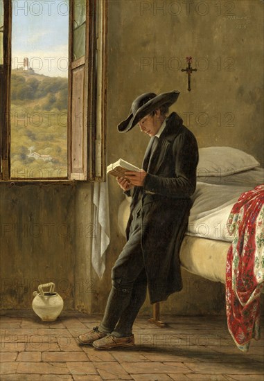 Young priest in his chamber reading a book