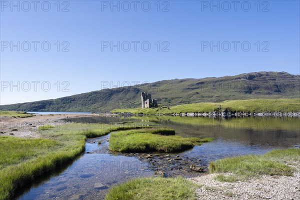 The ruins of Ardvreck Castle on a peninsula in the freshwater loch of Loch Assynt