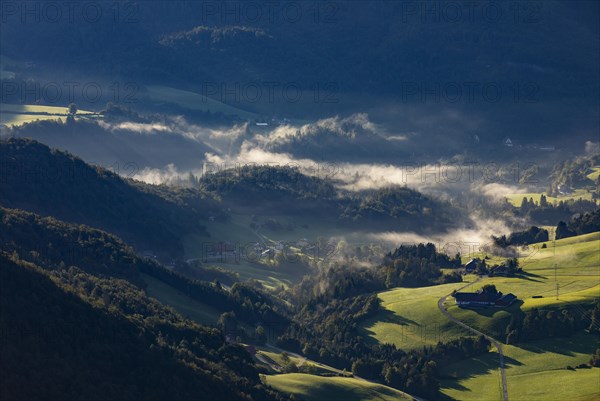 Farms at sunrise and morning fog near Ebenau