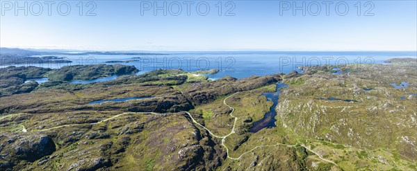 Aerial panorama of the sparsely populated Northwest Highlands with the single track road and pass road B869