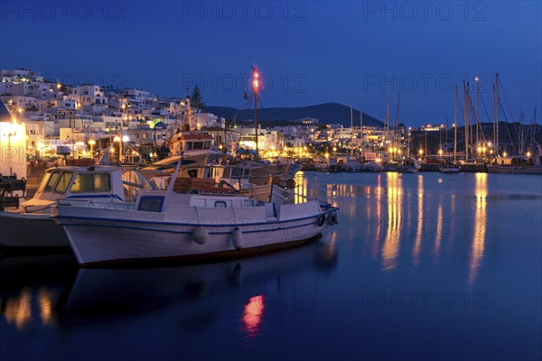Beautiful tradition Greek fishermen village on hilltop. Colorful boats moored by jetty