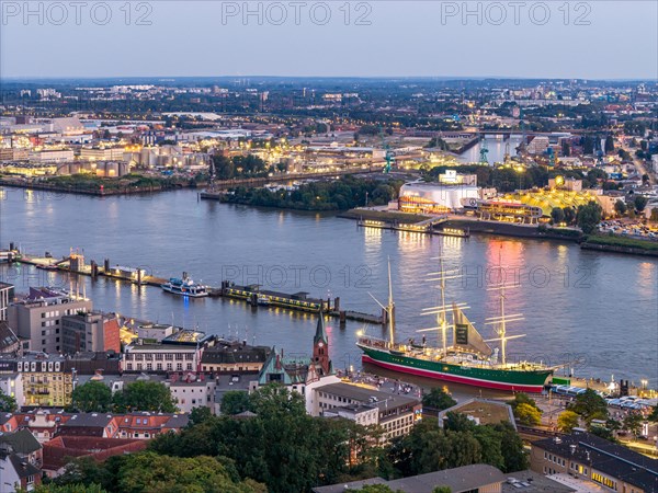 Aerial view of the port of Hamburg at blue hour with landing stages