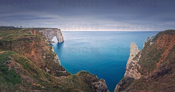 Beautiful panorama of the Porte d'Aval natural arch at Etretat famous cliffs