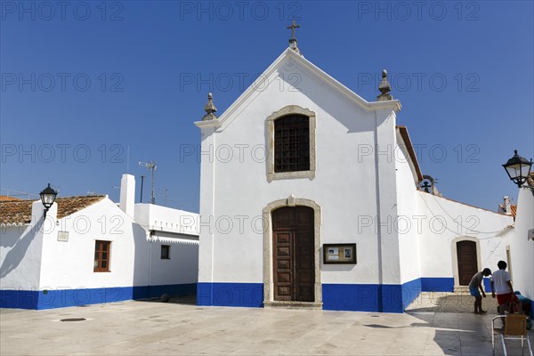 Church painted blue and white in village square