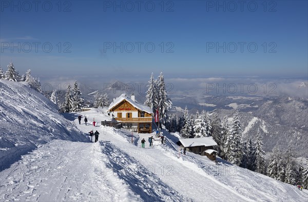 Winter landscape with ski tourers and alpine hut at Zwoelferhorn