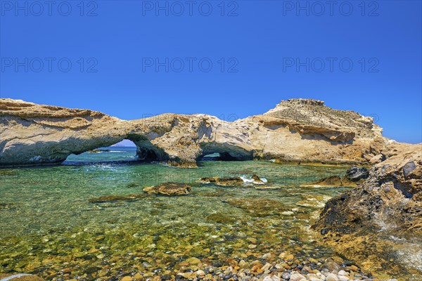 Sunny landscape of rocky small bay with azure clear sea waters