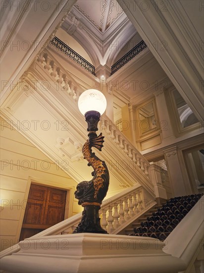 Luxurious stairwell with vintage lamp glowing in the hall of a 5 stars hotel