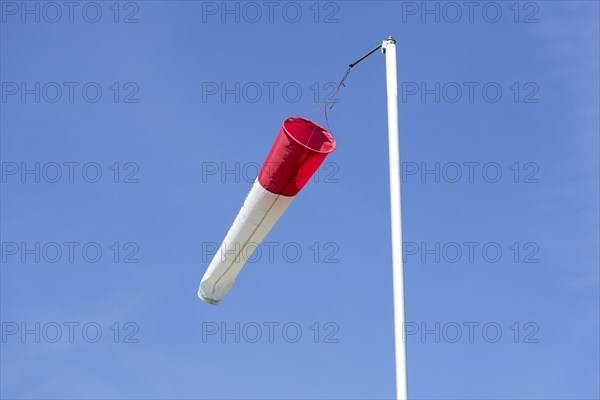 White-red windsock against blue sky