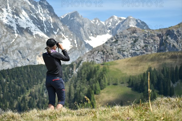 Hiker observing nature with binoculars in the Jenner area