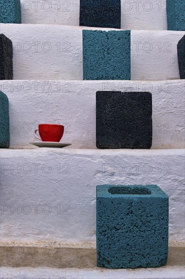 Close frontal shot of cubic flower pots in turquoise and black colors