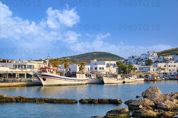 Beautiful tradition Greek fishermen village on hilltop. Colorful boats moored by jetty