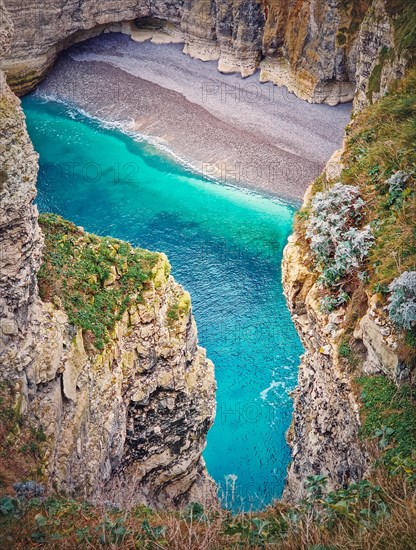 Famous Falaise d'Aval coastline cliffs and a bay with blue ocean water at Etretat