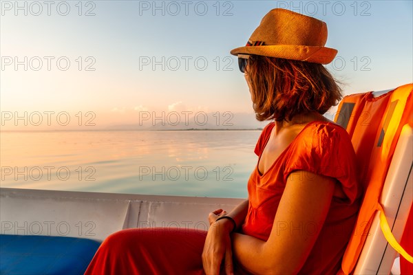 Tourist woman in a boat on a tourist excursion on Lake Shkoder in Shiroka. Albania
