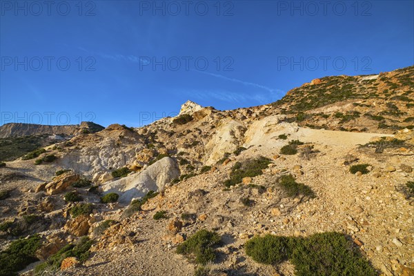 Unique natural rock formations of yellow and orange cliffs in low sunlight