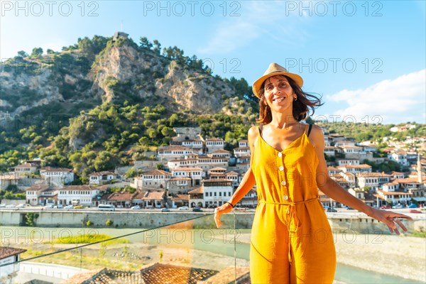 Portrait of a young woman looking at the historic city of Berat in Albania from a viewpoint