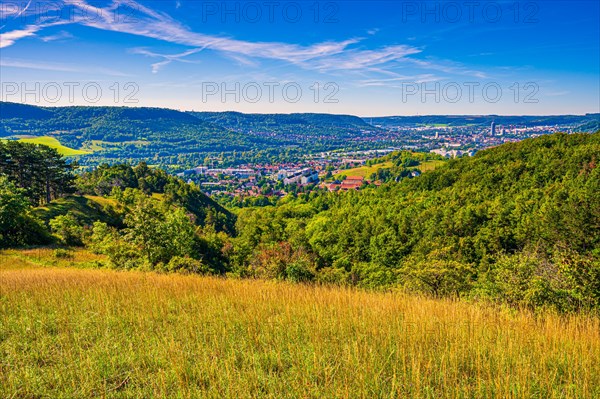 View over the city of Jena from the Galgenberg with the Kernberge in the background under blue sky and veil clouds