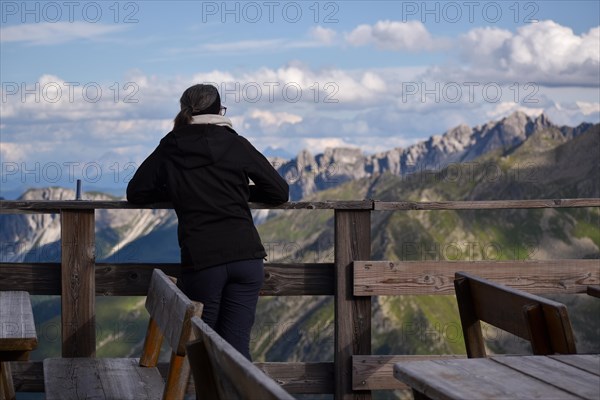 Mountaineer on the terrace of the Magdeburger Huette enjoying the evening mood