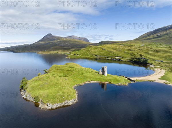 Aerial view of the freshwater loch Loch Assynt with the ruins of Ardvreck Castle on a peninsula