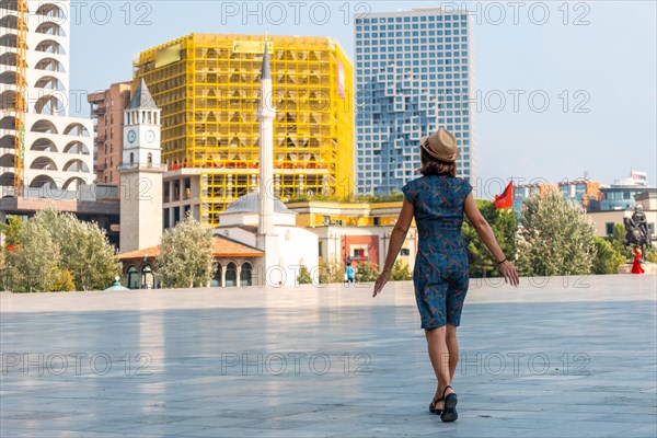 A tourist walking on vacation through Skanderbeg Square in Tirana. Albania