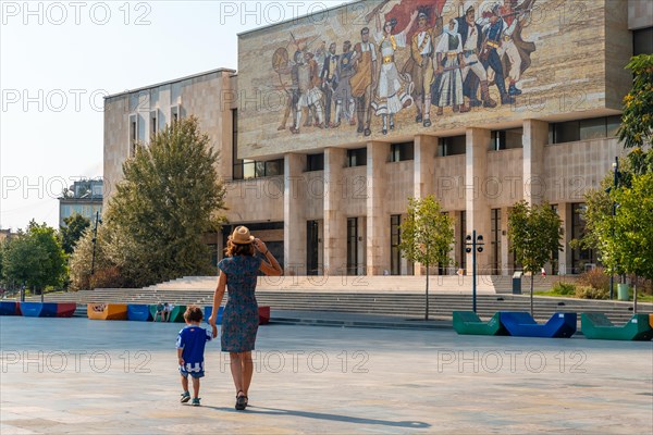 A mother with her son visiting the National Historical Museum in Skanderbeg Square in Tirana. Albania