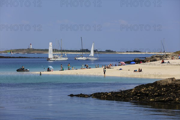 Sandy beach beach with bathers and sailboats