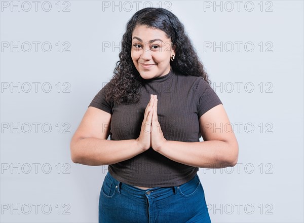 Smiling girl asking for a favor. Happy people asking for a favor. Beautiful latin girl asking for a favor isolated