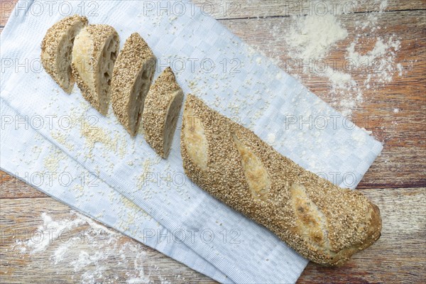 Freshly baked vegan baguette with sesame seeds