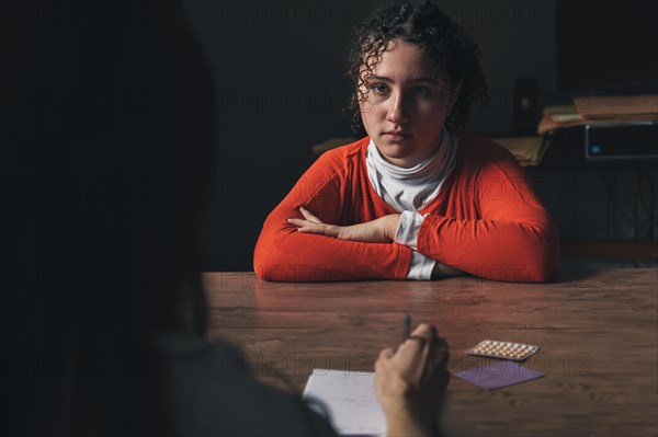 Young teenage girl receiving the oral contraceptive pill from her doctor at the hospital