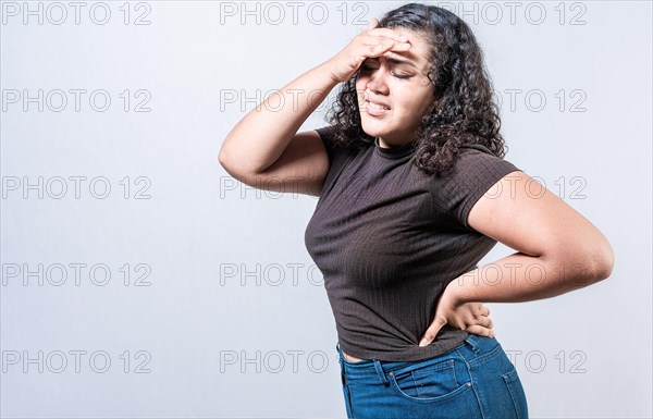 Worried young woman holding his forehead. Worried girl isolated. Tired woman holding his head