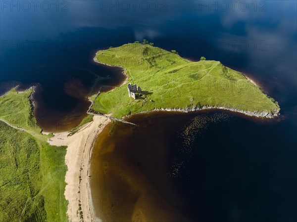 Aerial view of the freshwater loch Loch Assynt with the ruins of Ardvreck Castle on a peninsula