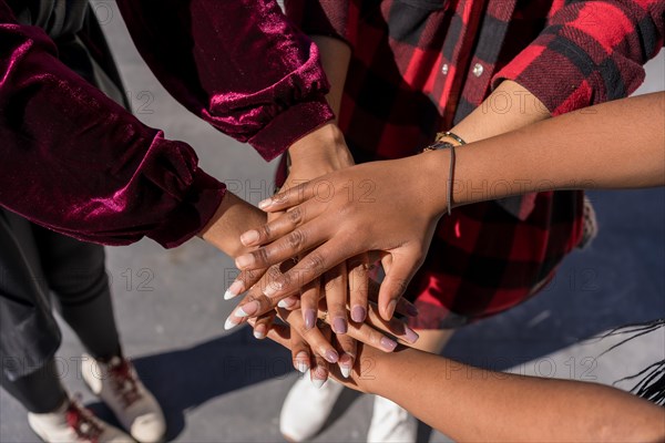 Top view of women joining hands together. Team and support concept